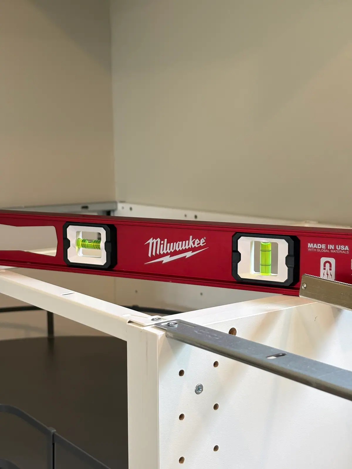 Cabinet frame being checked with a level